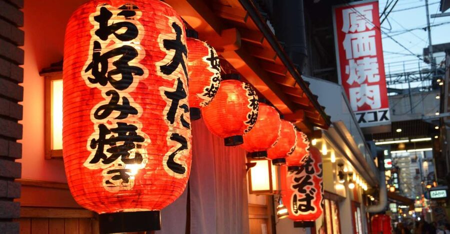 Osaka: Food Tour at Night with Tastings - A small group helps in a crowded district